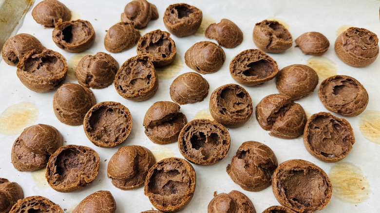 Sliced chocolate pastries on baking sheet