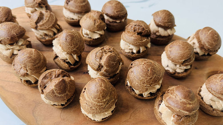 Chocolate cream puffs on wooden board