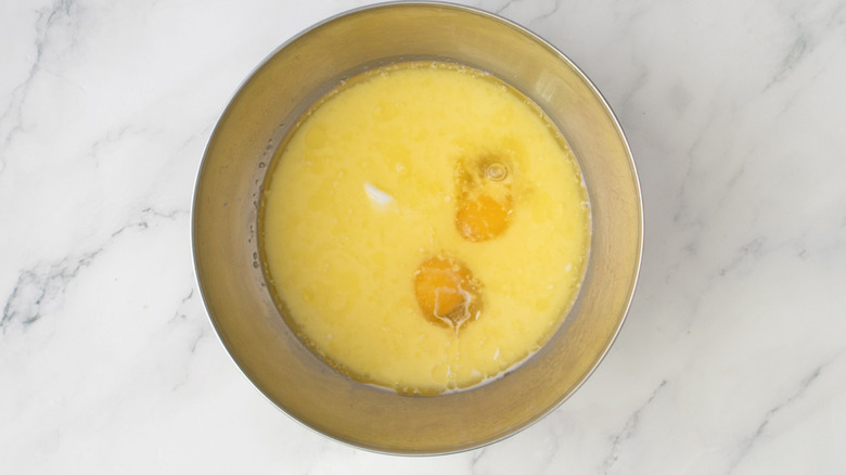 Egg and milk mixture in bowl on marble surface