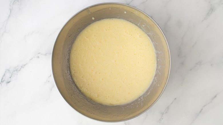 Milky mixture in bowl on marble surface