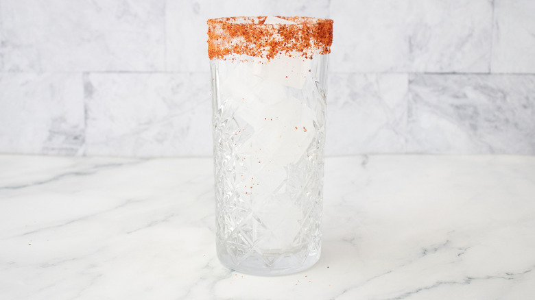 Tajín-rimmed glass filled with ice