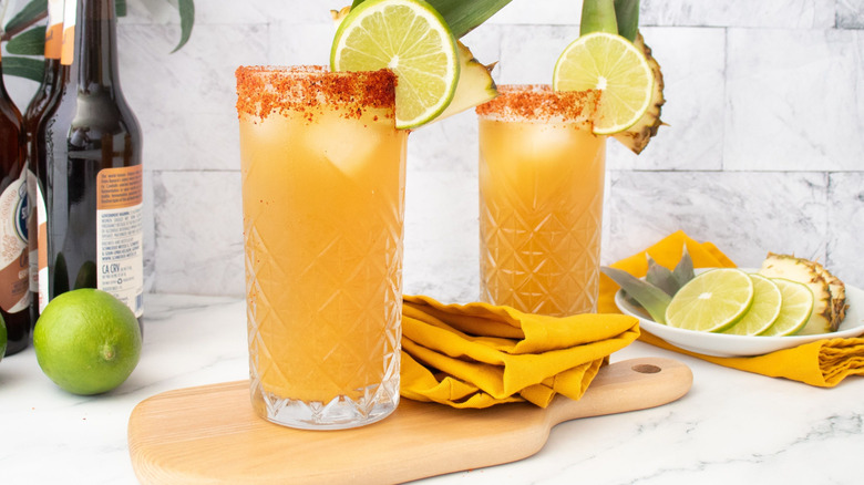 Tropical rum shandies in glassed with Tajín rims