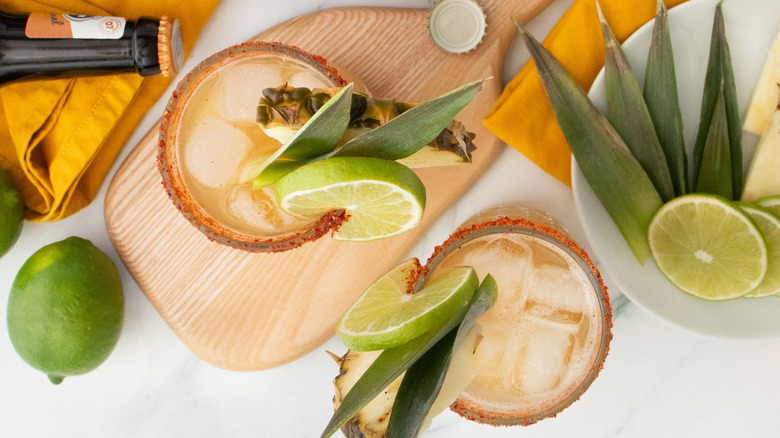 Top-down view of tropical rum shandies with garnishes
