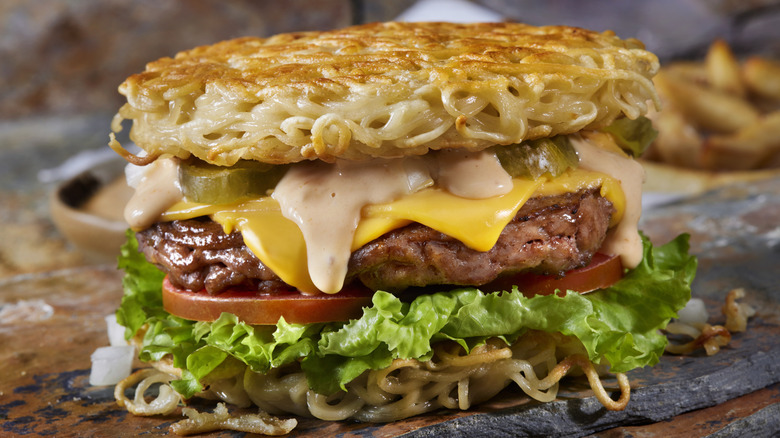 a loaded ramen burger with condiments, aromatics