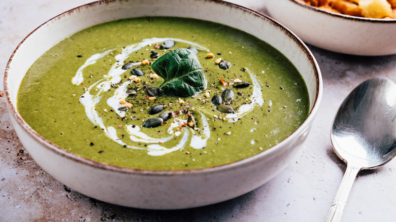 green veggie bisque garnished with cream