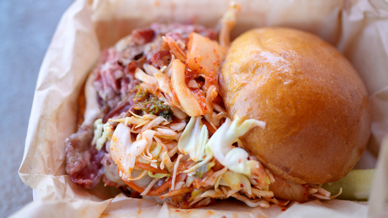 Pork and kimchi sandwich with a bun
