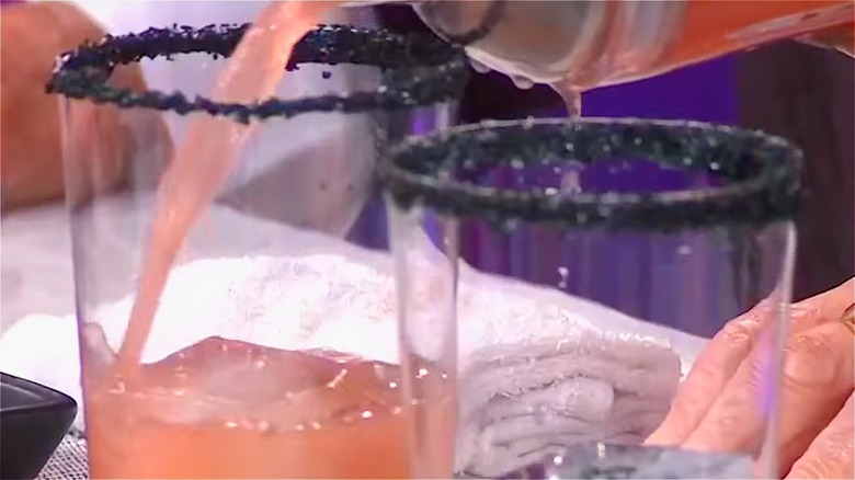 a black salt rimmed glass with a salty dog cocktail