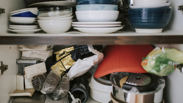 messy disorganized cabinet interior