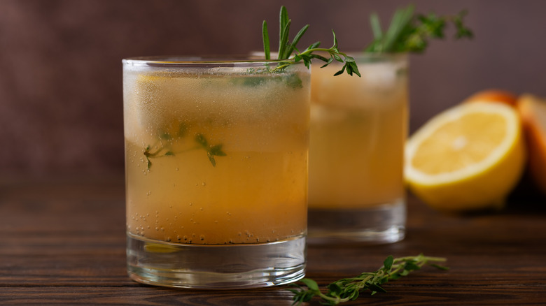 Dark lemonade with herbs in a glass