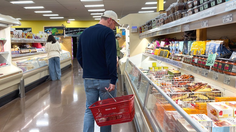 Man perusing the frozen section at Trader Joe's