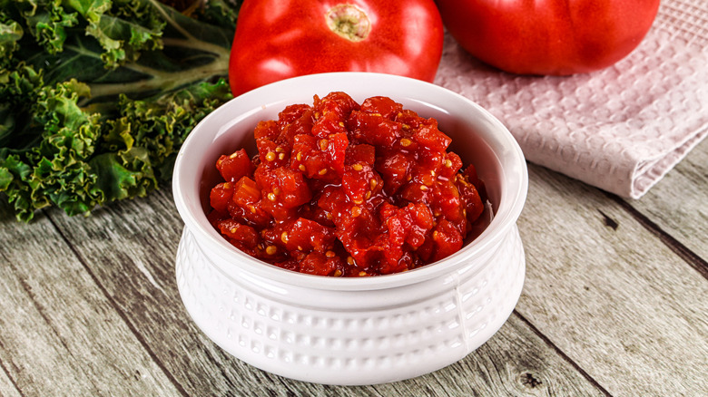 Diced stewed tomatoes in a white bowl.