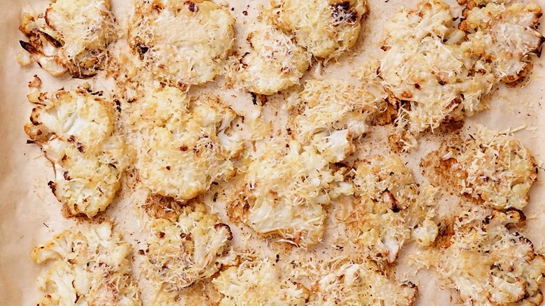 Smashed parmesan cauliflower on parchment paper