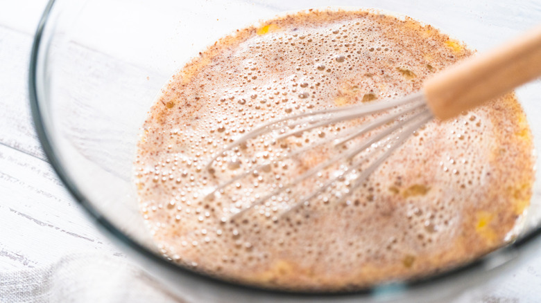 French toast batter is whisked in a bowl.