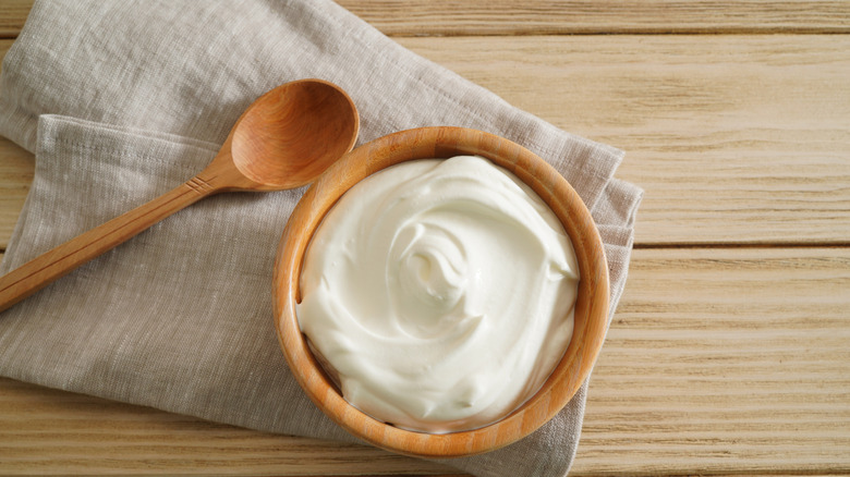 greek yogurt in a bowl on a wooden table