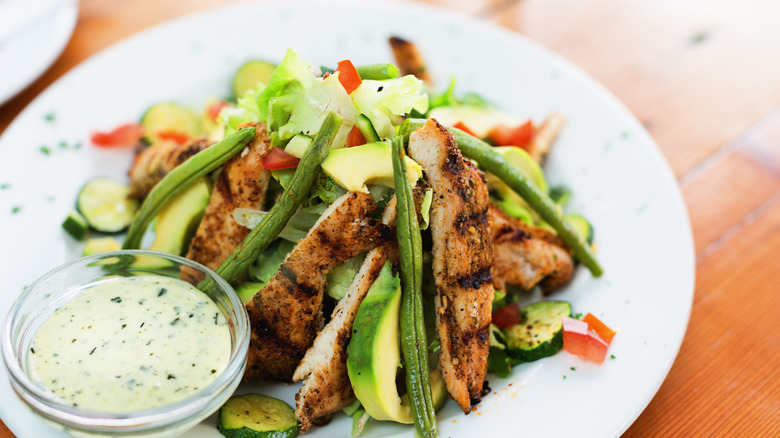 Avocado dressing on plate with salad