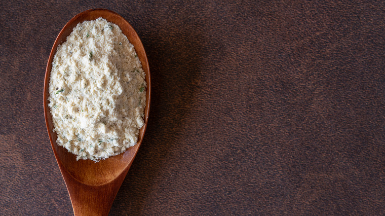 A wooden spoon filled with ranch seasoning.