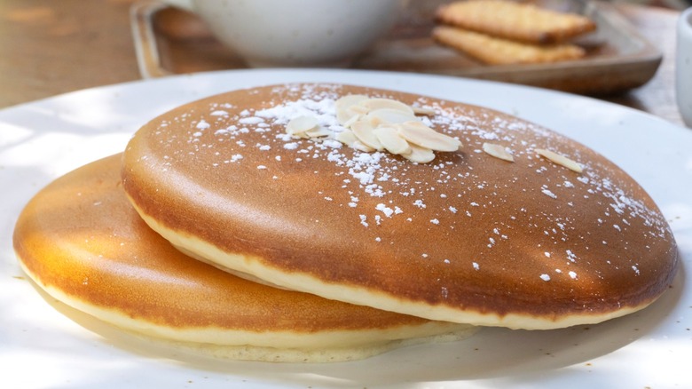 Two fluffy pancakes with powdered sugar