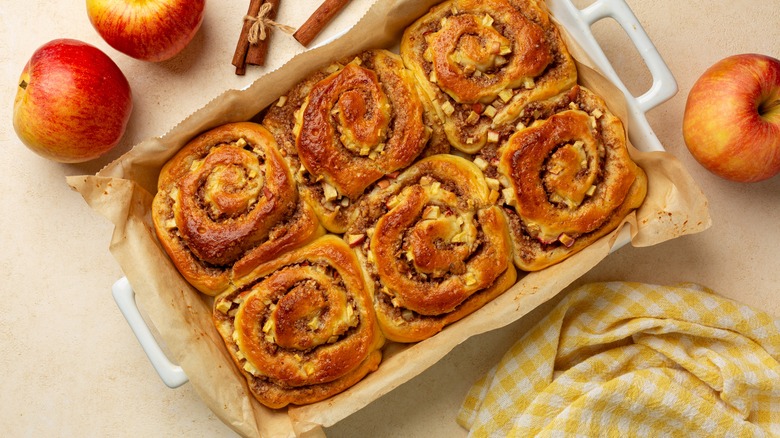 cinammon rolls in a backing tray with baking paper