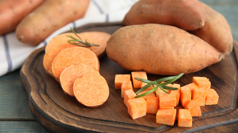 Slices and cubes of sweet potatoes on a board