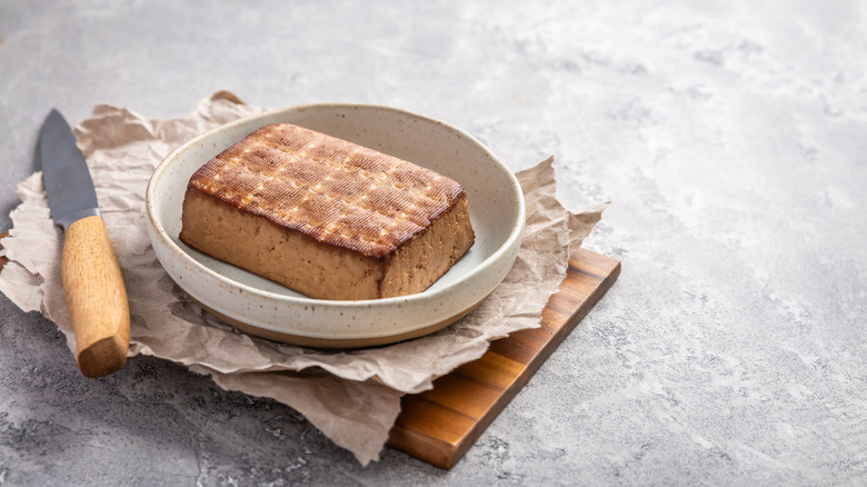 smoked tofu with knife