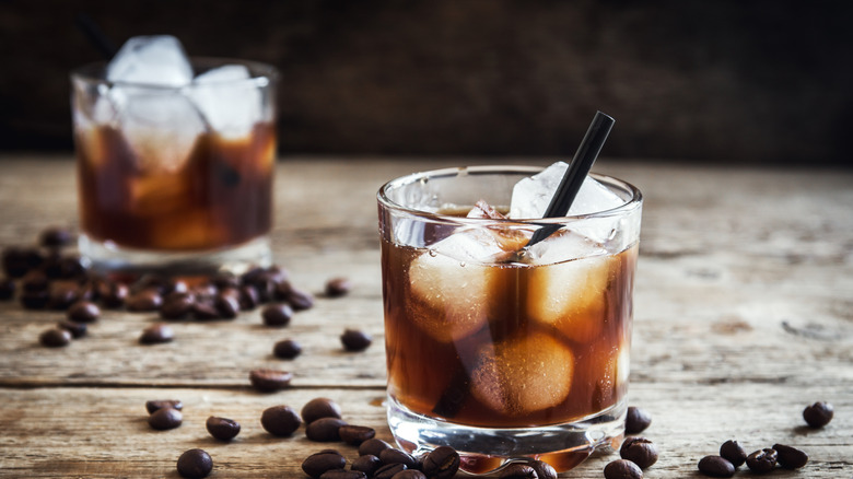 Black Russian cocktails served over ice surrounded by whole coffee beans