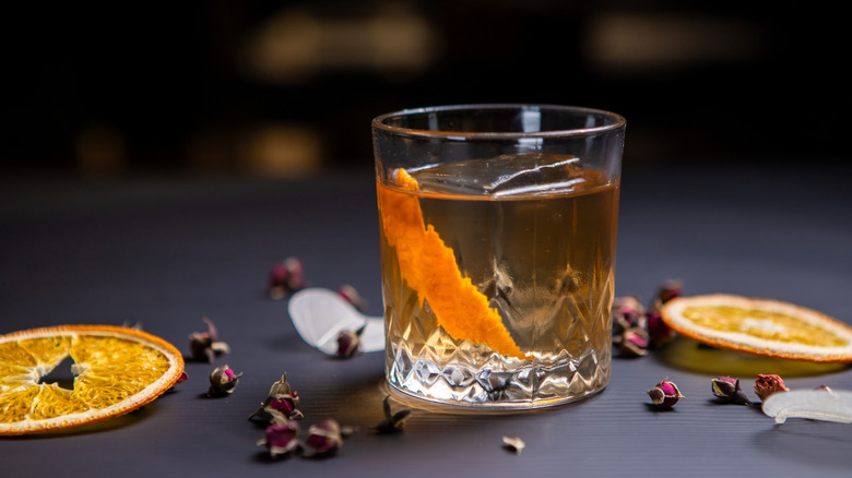 A godfather cocktial garnished with an orange twist