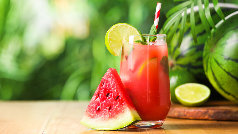 A freshly made watermelon drink is garnished with lime