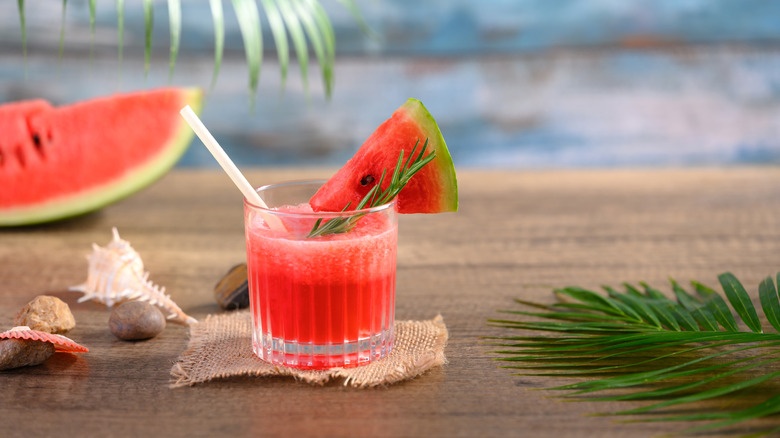A watermelon beverage sits on a wooden surface.