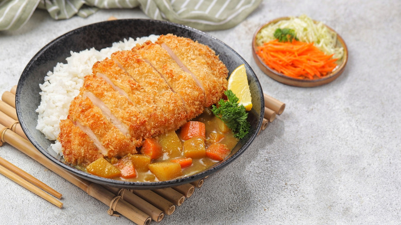 Sliced chicken katsu over rice and curry
