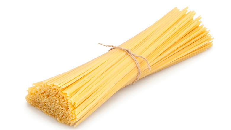 A bundle of linguine tied together with twine