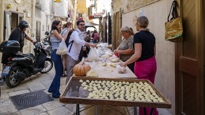 Ladies selling fresh orecchiette in Bari, Italy