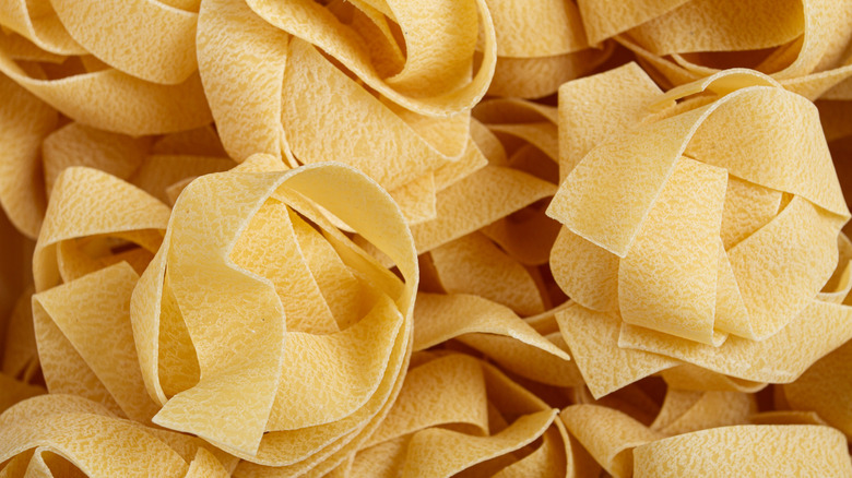 overhead view of bundles of dried pappardelle pasta
