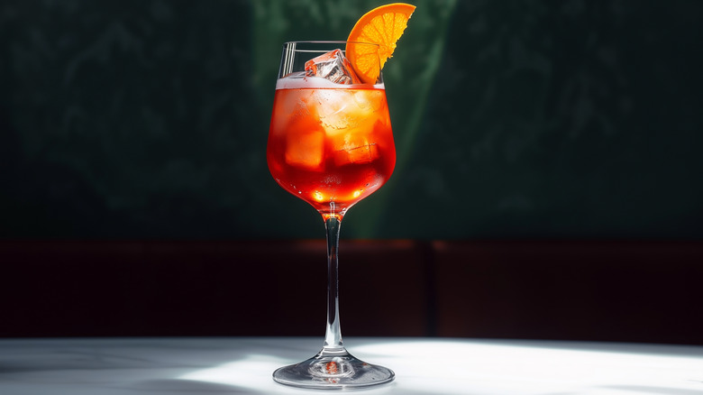 A Campari spritz with a orange slice.
