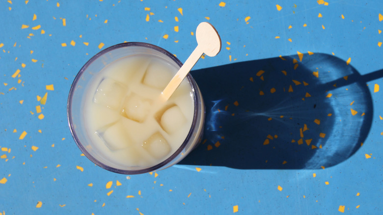 A Ricard spritz on a blue yellow splatter table.