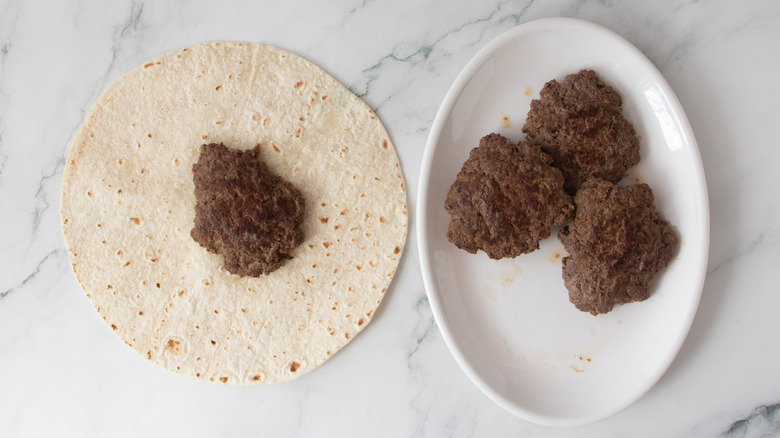 burger patty on flour tortilla
