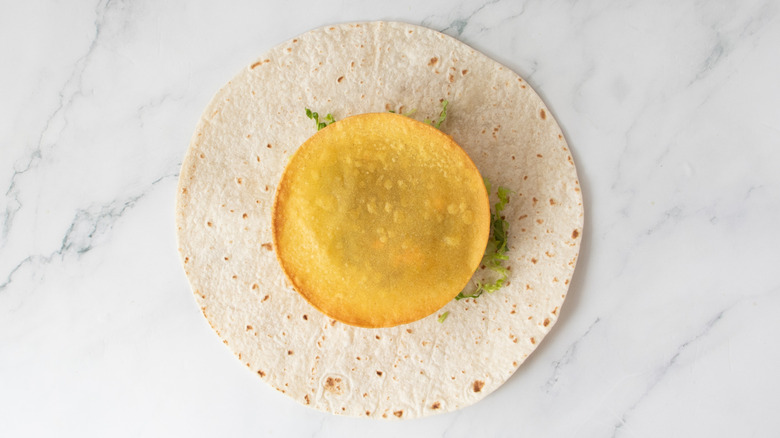 tostada on top of tortilla with smash burger