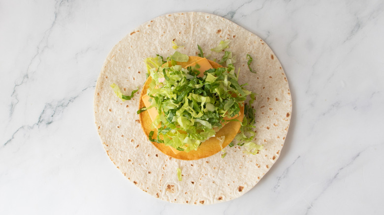 double stacked smash burger and toppings on a tortilla
