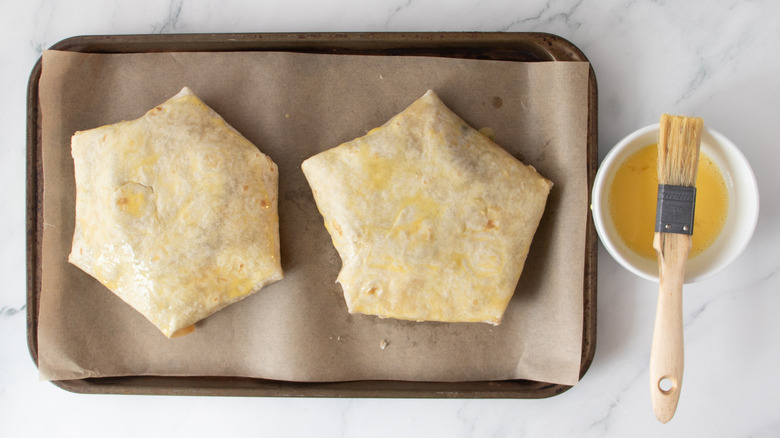 crunch wraps on baking sheet brushed with egg