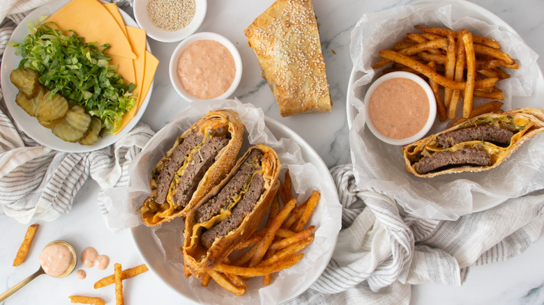 smash burger crunch wraps on counter with fries