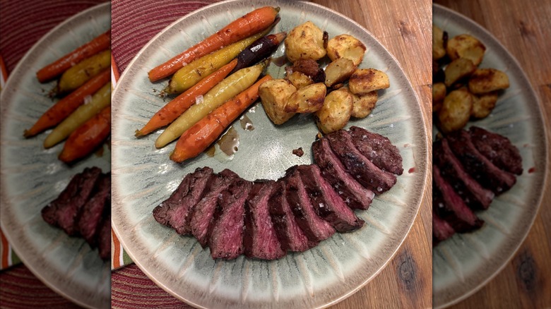 Hanger steak served with potatoes and carrots