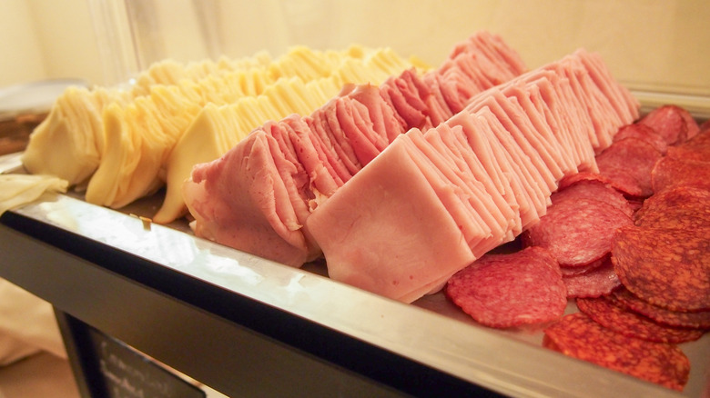 A display of ham, cheese, and salami.