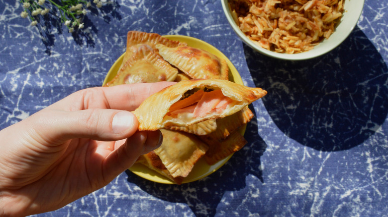 Mini hand pies filled with sausages, apples, and cheese.
