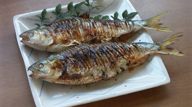 Two dotted gizzard shad fish on a plate