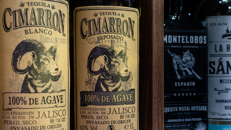 A closeup shot of a bottle of Cimarron with two more in the background