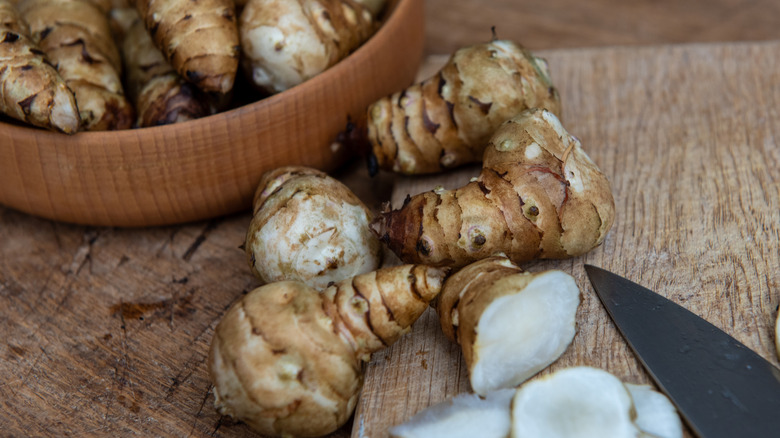 sunchokes, whole and sliced, on a cutting board
