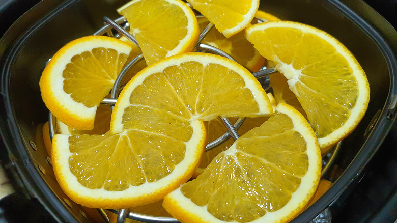 Fresh orange slices in an air fryer