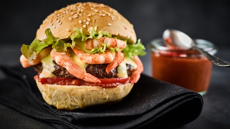 Surf and turf cheeseburger featuring beef and shrimp