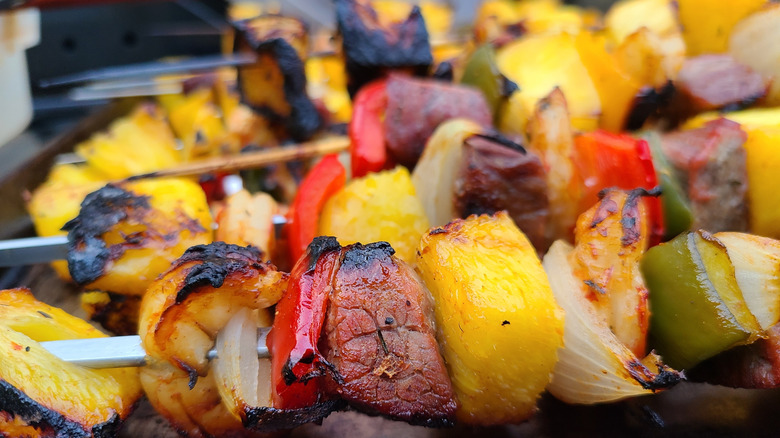 Steak and shrimp kebabs with pineapple, onions, and bell peppers