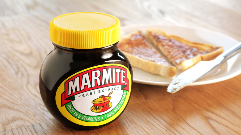 Jar of Marmite with plate of Marmite toast