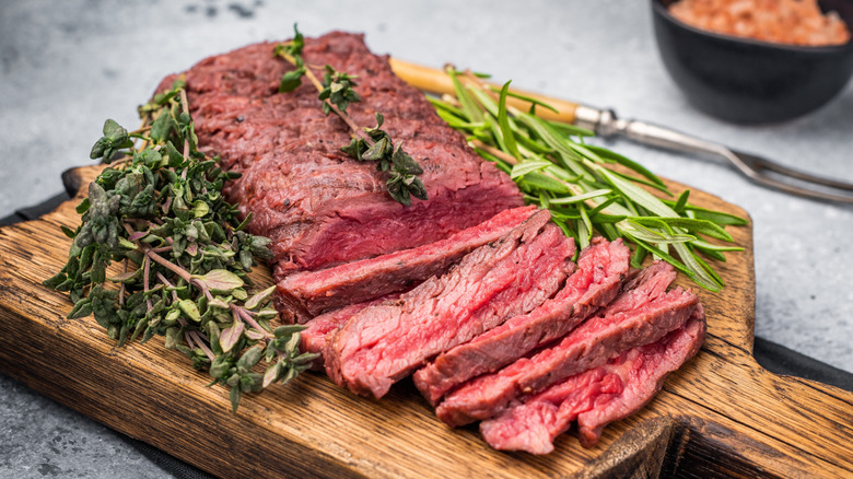 Grilled flank steak on wooden board